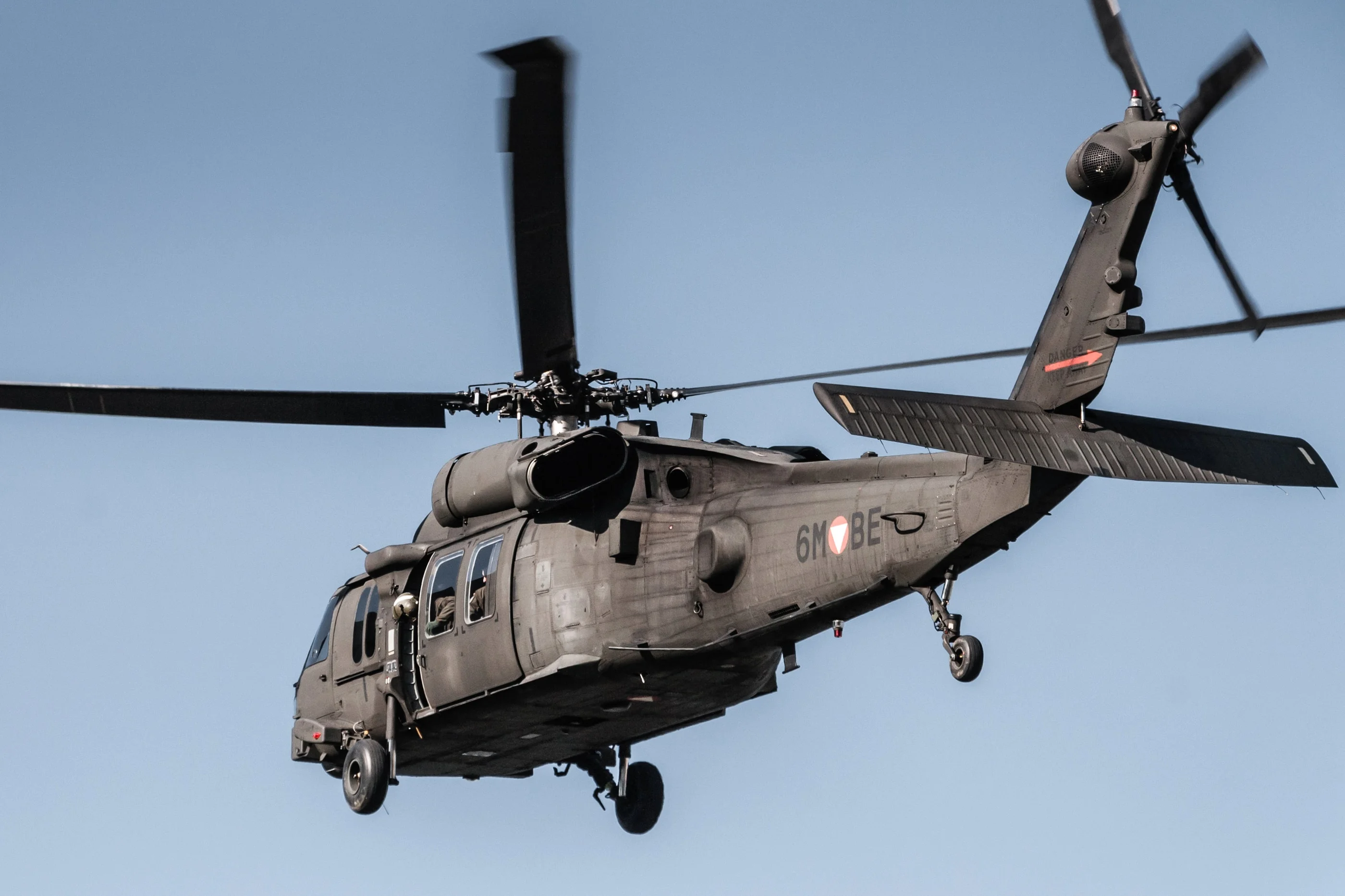 Austrian Armed Forces Black Hawk helicopter in flight with its landing gear down