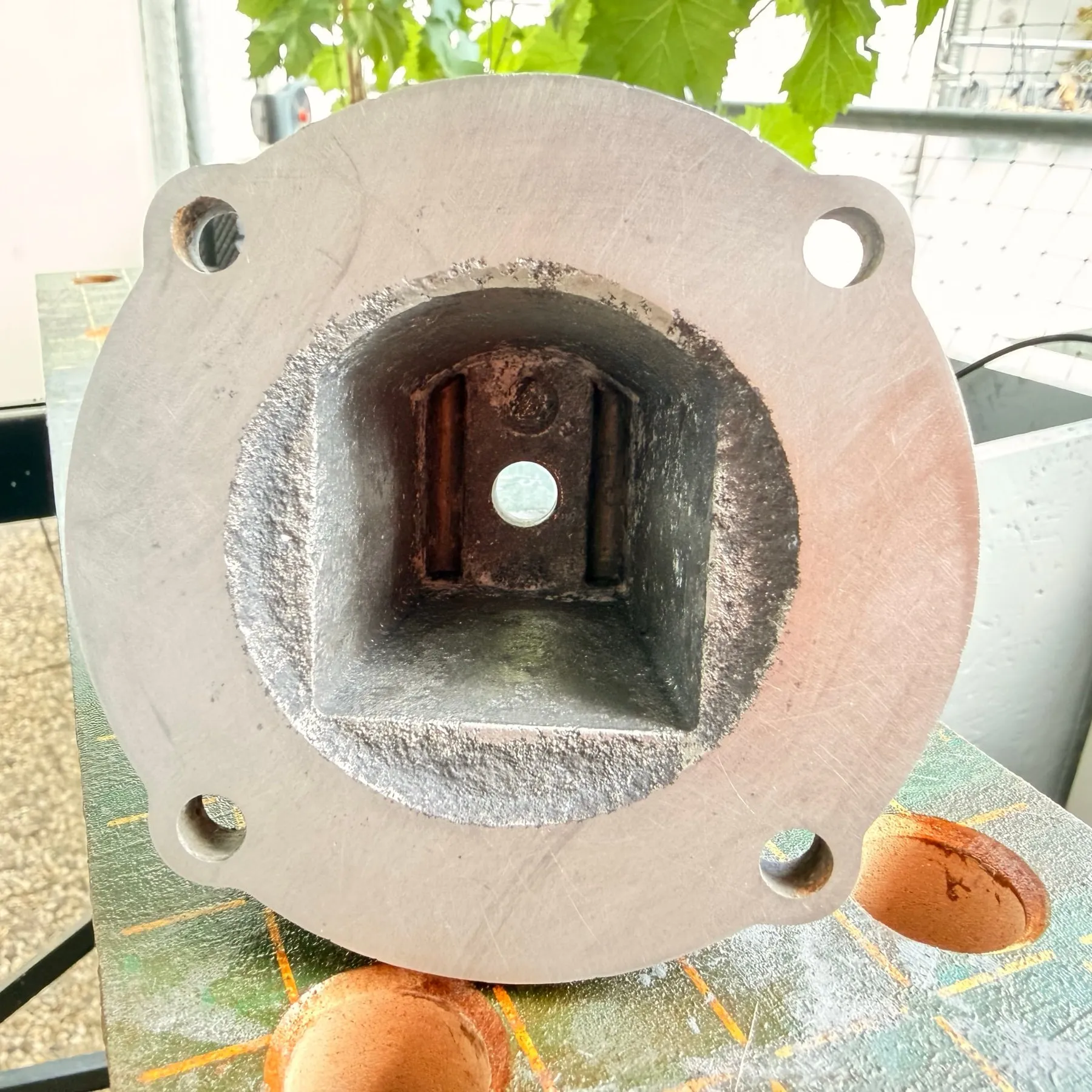 The same cavity and flange on 21 July: bare, grey, etched aluminium, the lapped flange face bright and even