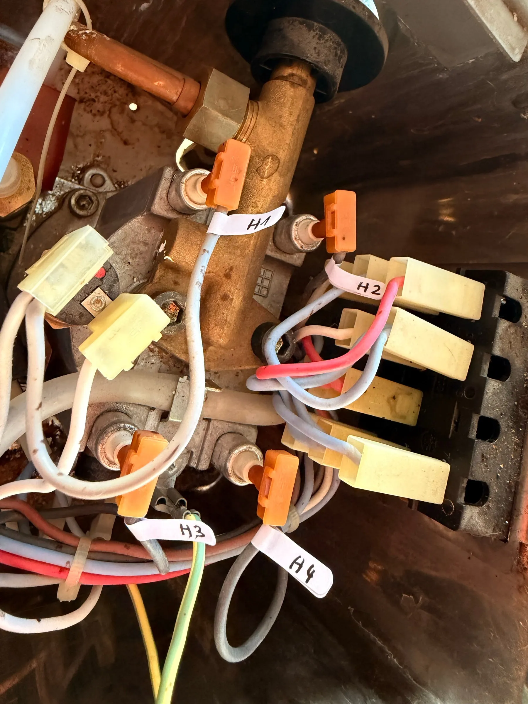 Brass boiler fittings with orange spade terminals, each wire carrying a hand-written tape flag reading H1, H2, H3 and H4