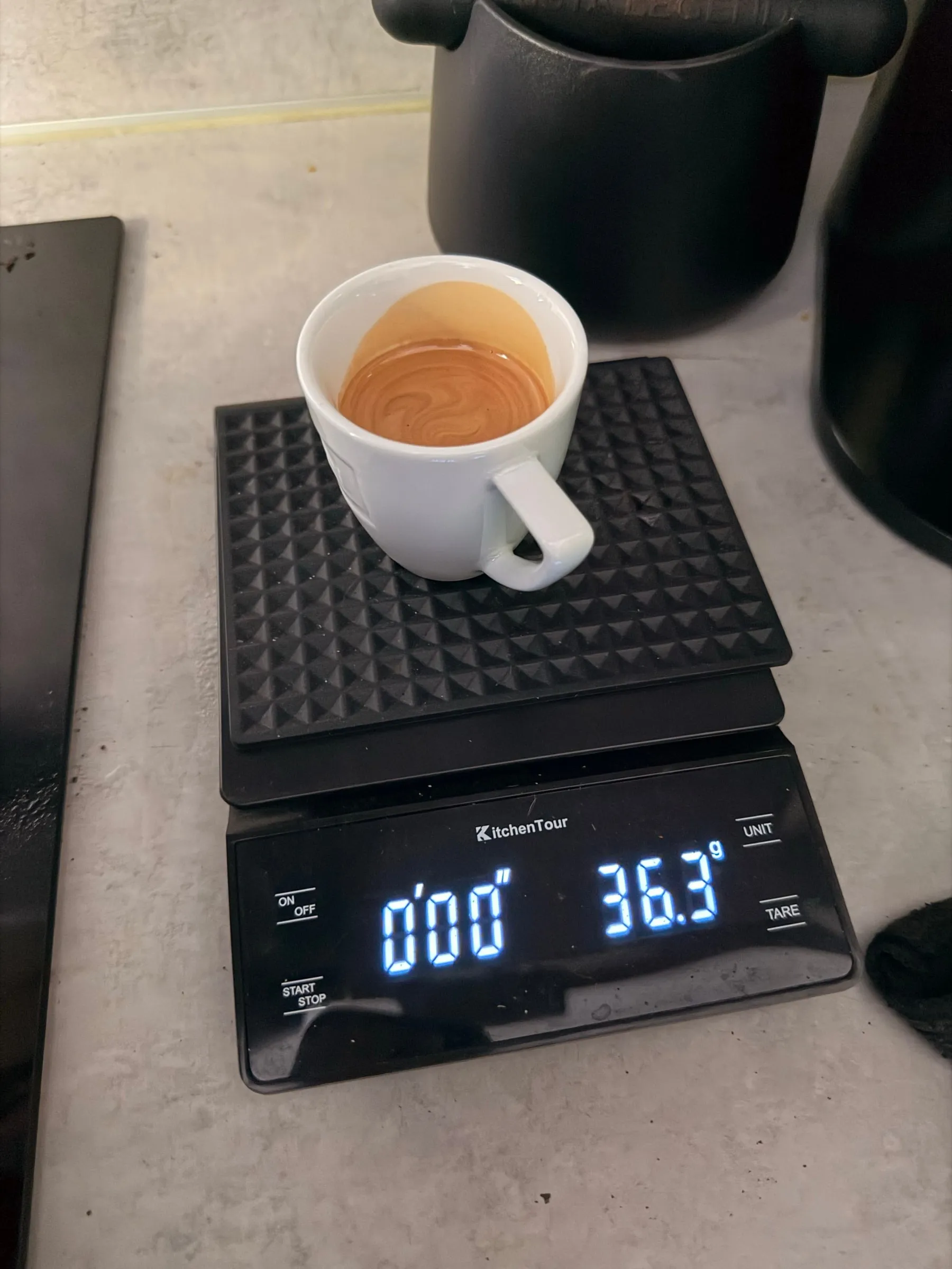 The same cup on the same scale after the second shot, the scale reading 36.3 grams