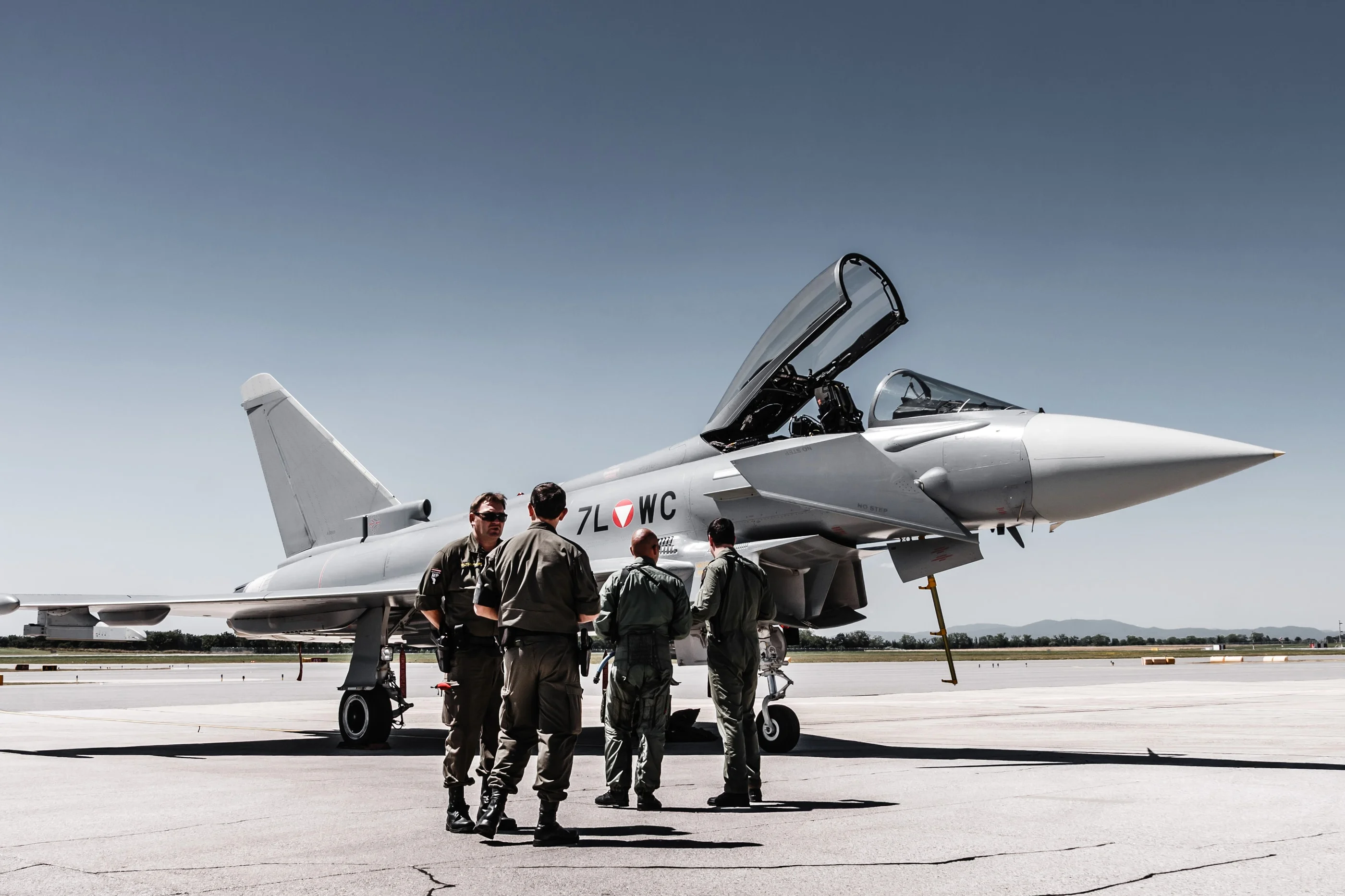 Pilots and ground crew talking in front of a Eurofighter
