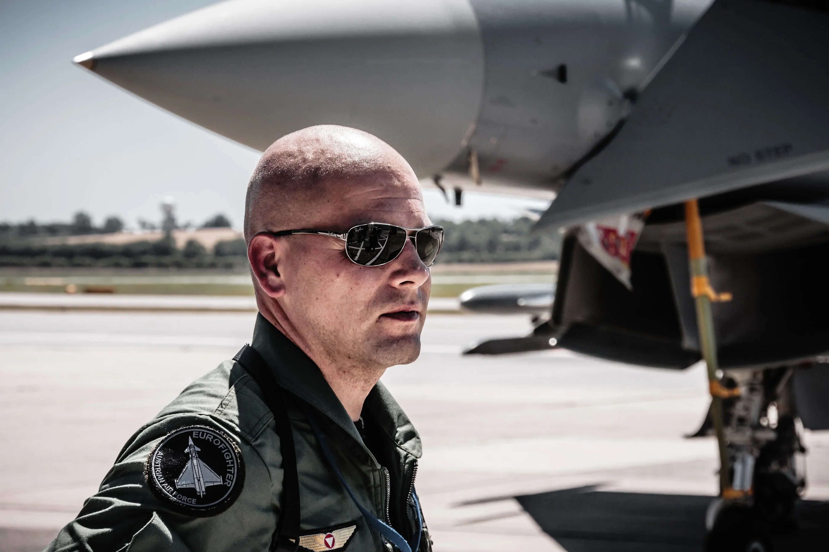 Portrait of a Eurofighter pilot in sunglasses under the nose of the jet