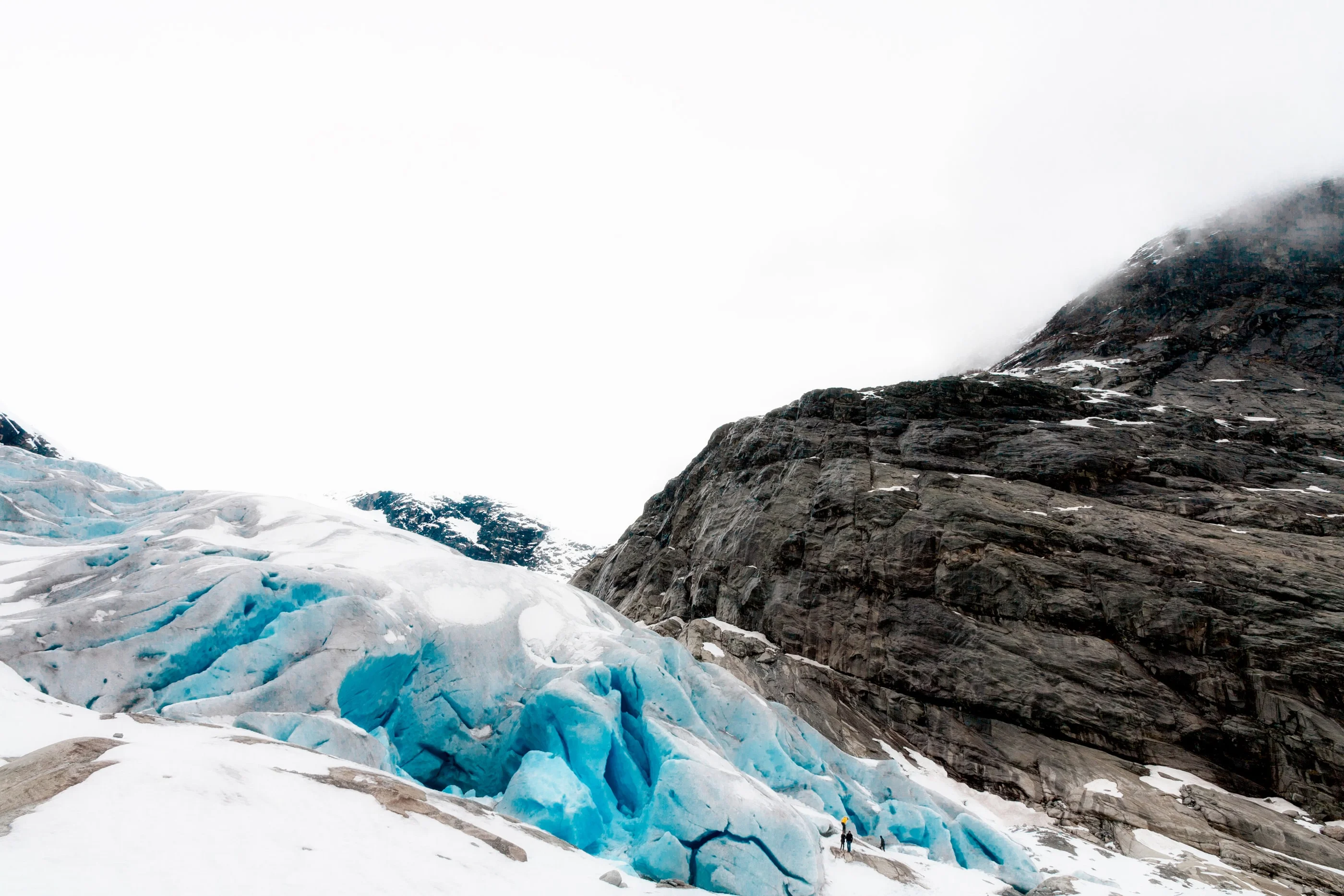 Close-up of the blue glacier front below a cliff