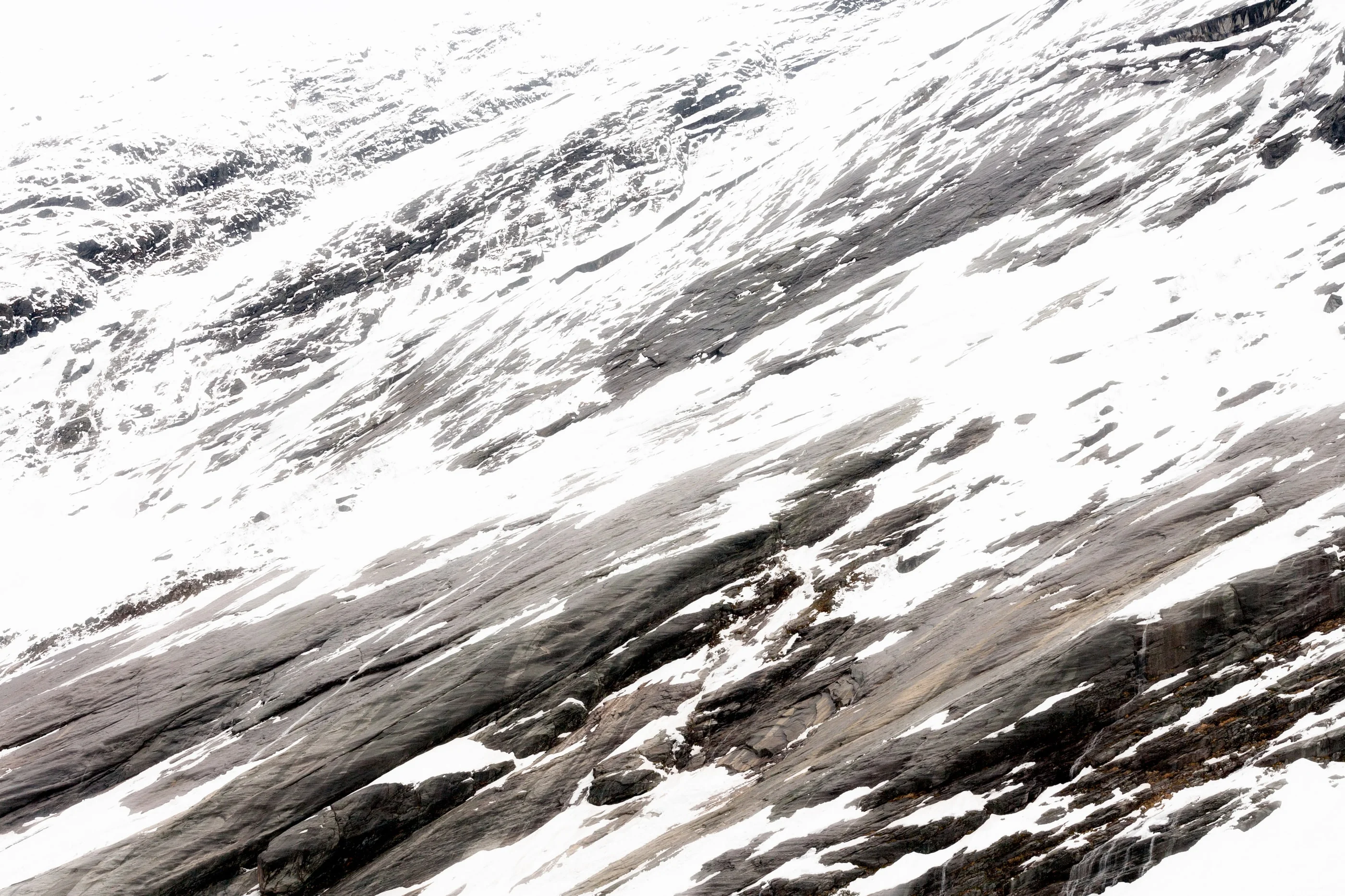 Diagonal rock slabs covered in snow