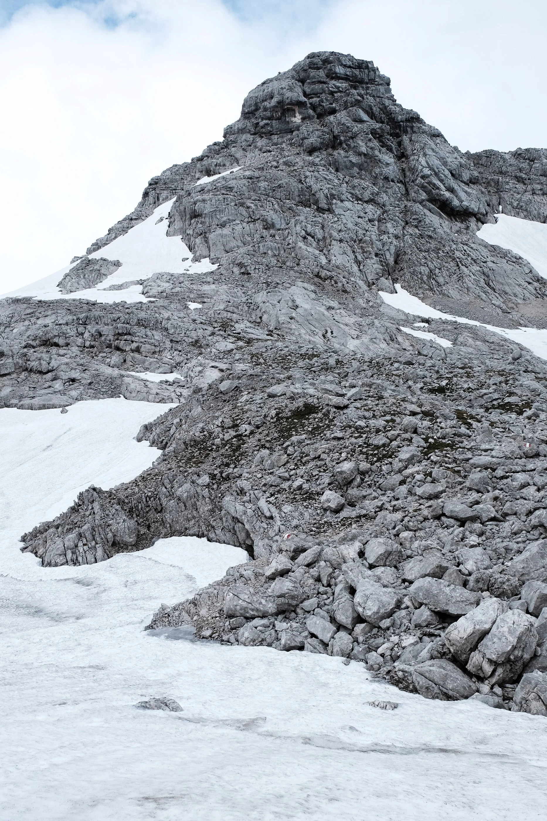 Rocky peak above patches of snow