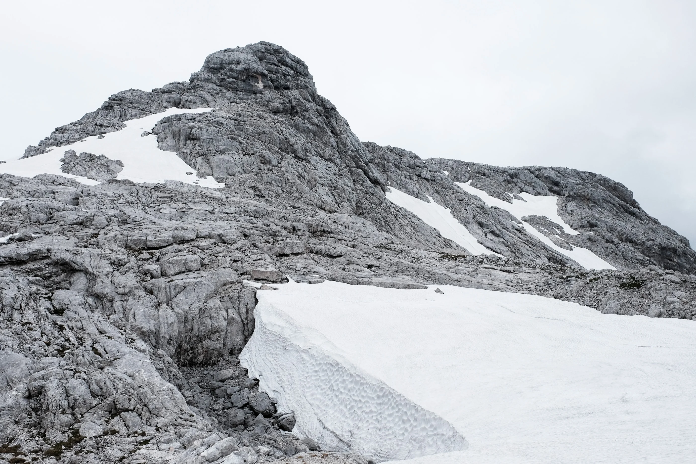 Rounded limestone ridge with a snowfield