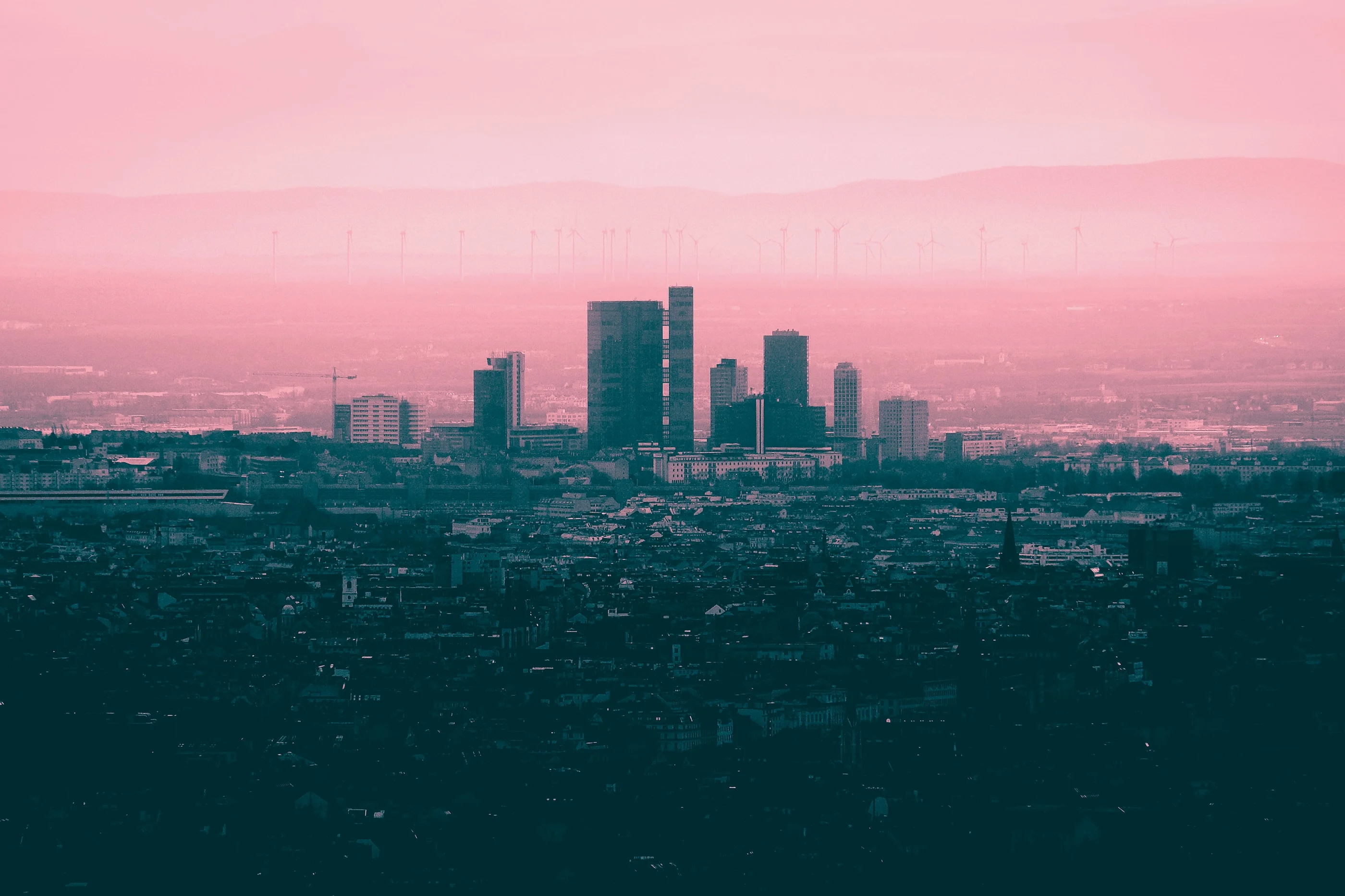 Vienna skyline with high-rise towers under a pink haze